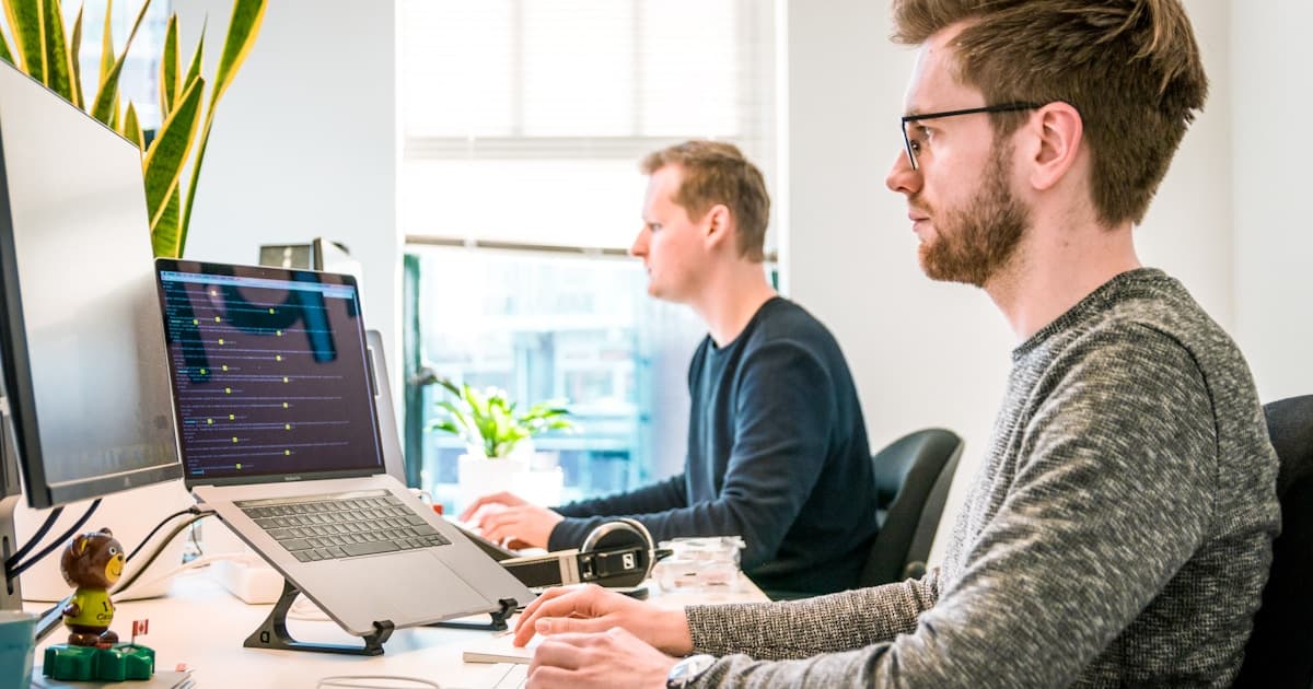 Office scene contrasting someone leaving and someone staying at work